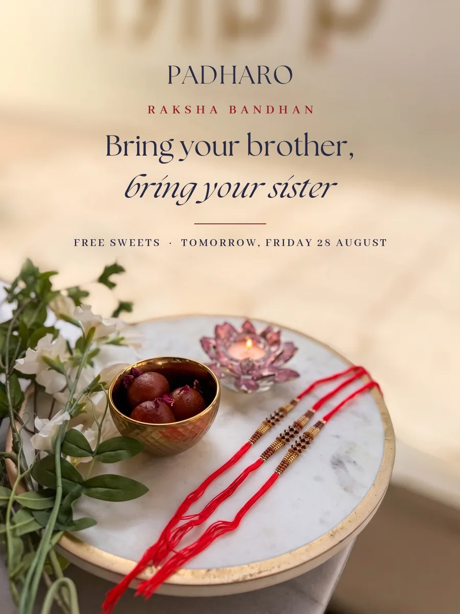 Raksha Bandhan post: bring your brother, bring your sister, above a marble table with sweets, a lotus candle and three rakhis
